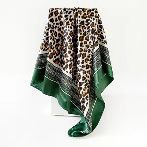 Detailed view of 90cm leopard print satin square scarf with elegant green border for women.