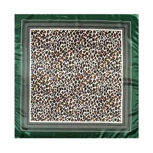 Exquisite leopard print silk scarf detail, featuring classic pattern and green border trim.