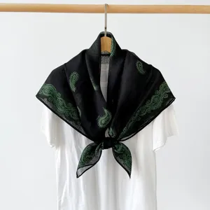Black paisley square scarf detail, elegant retro floral print hijab or neckerchief accessory.