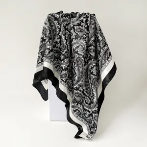 Detail view of the black and white satin paisley spliced square scarf, elegant 90cm texture.