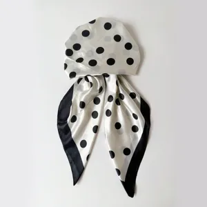 Detailed view of the black and white polka dot satin head scarf cap, smooth texture and nice print.