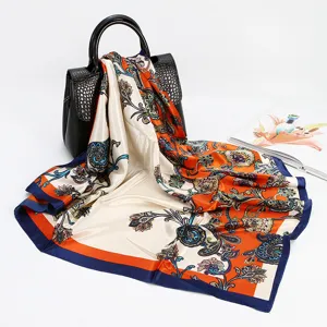 Elegant paisley printed silk feel square scarf for women, classic orange and blue design.