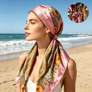 Close-up detail view of the silky paisley print headscarf worn outdoors at sunny beach.