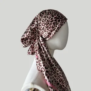 Detail view of women's leopard print satin headscarf, silky smooth fabric and side knot design.