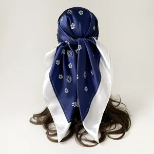 Blue and white silk-feel satin square scarf with elegant camellia pattern for women.