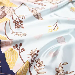 Detailed view of 90cm square silk satin scarf with elegant botanical and seashell print.