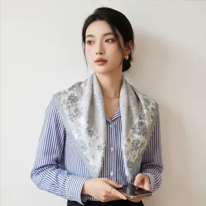 Detail shot of women's 90cm floral print silk square scarf, elegant twill fabric styling.