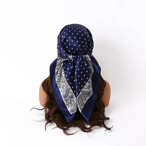 Detailed view of the 88cm satin square scarf with polka dot and paisley patchwork print.