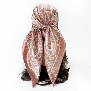 Detailed view of the brown paisley satin headscarf, showcasing exquisite floral print and fabric texture.