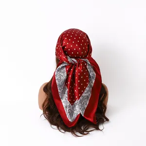 Detail view of 88cm satin square scarf featuring red polka dots and paisley print design.