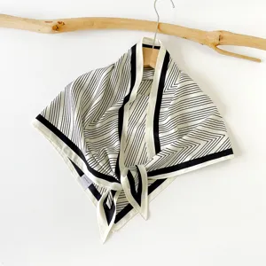 Chic black and white striped silk twill triangle scarf for women, elegant summer fashion accessory.