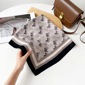 Details of the vintage horse and carriage print square scarf with classic striped border.