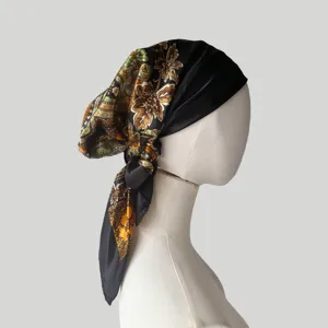 Nahaufnahme des Satinkopftuchs mit Paisleyblumenmuster und edler glänzender Textur.