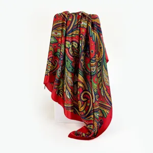 Classic red paisley print satin silk scarf detail showing intricate colorful design.