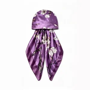 Purple satin floral print headscarf cap detail shot showing exquisite fabric texture and elegant branch pattern.