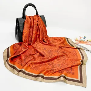 Orange paisley square silk scarf for women, elegant satin headscarf and neck wrap accessory.
