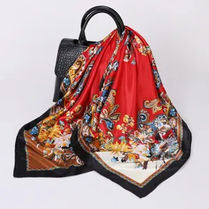 Detailed view of a luxurious 90cm satin silk square scarf with vibrant floral and paisley print.