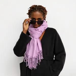 Lavender fringed winter scarf detail view, soft cashmere-feel fabric shown worn by model.