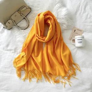 Detailed view of solid color imitation cashmere fringe scarf, soft texture and elegant design.