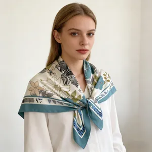 Close-up detail of women's 90cm square silk scarf with elegant floral abstract pattern.