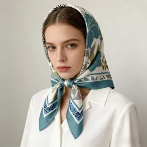 Model wearing elegant silk square headscarf, detailed blue floral print pattern style.