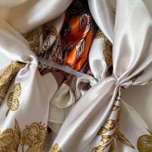 Detailed view of the silky satin headscarf cap, featuring glossy fabric and exquisite botanical print.