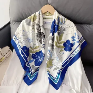 Exquisite floral print silk scarf detail, showcasing elegant blue and white pattern design.