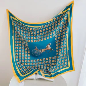 Detail view of the 90cm square silk scarf featuring a luxury carriage print and belt border.