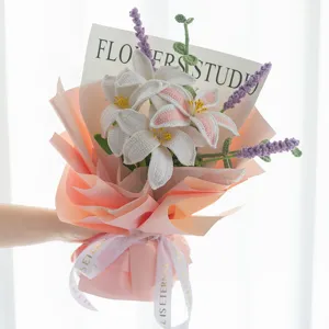 Handmade crochet lily and lavender flower bouquet finished product with pink wrapping paper.