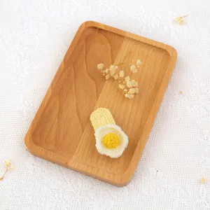 Handmade crochet fried egg hair clip, cute yarn hairpin detail shot with wooden tray.