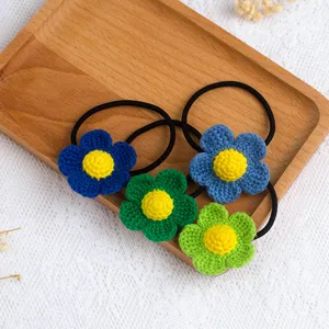 Detailed close-up of handmade crochet flower hair ties with vibrant colors and cute design.