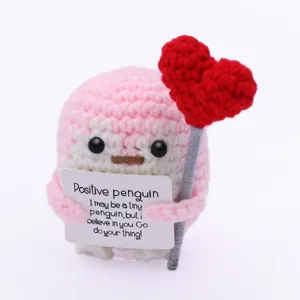 Handmade crochet positive penguin plush toy with heart and encouraging message card.