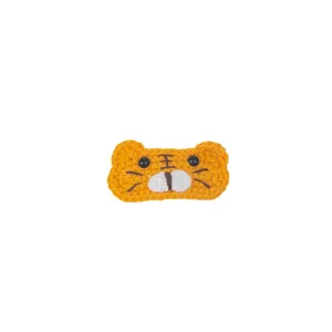 Close-up detail of the handmade crochet tiger hair clip featuring cute embroidered whiskers.