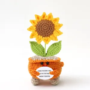 Detailed shot of handmade crochet sunflower potted doll with sweet encouraging message card.