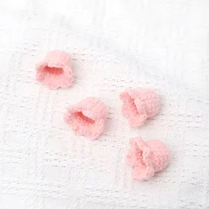 Handmade crochet pink flower heads detail close up view for knitting decor supplies.