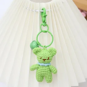 Handmade crochet green bear keychain detail, cute plush toy bag pendant accessory.