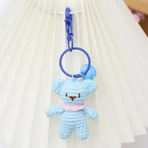 Handcrafted crochet bear keychain, cute blue yarn doll charm for bags, soft handmade accessory.