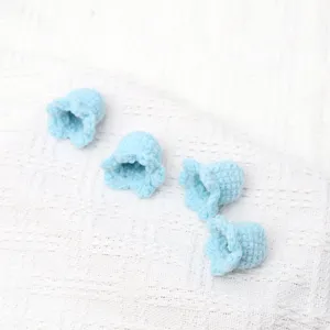 Handmade crochet lily of the valley flower heads, light blue knit small floral DIY craft.