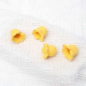 Handcrafted yellow crochet lily of the valley flower heads, soft yarn knit DIY accessories for floral decor.