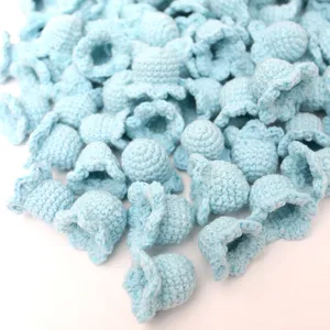 Handmade crochet lily of the valley flower heads, blue knitted yarn DIY craft floral decor.