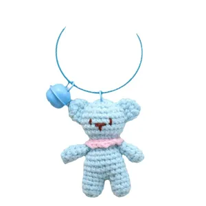 Handmade crochet light blue bear pendant with bell, cute knitted plush bag keychain accessory.