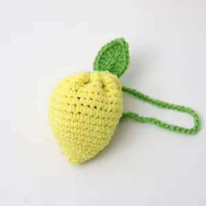 Handmade crochet lemon coin purse cute wool knit fruit bag children fashion accessory detail view.