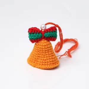 Handmade crochet bell ornament with red green bow, perfect for hanging decor and DIY crafts.