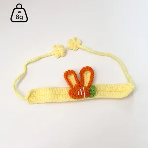 Close-up of handmade crochet pet collar with cute carrot and rabbit ears design details.