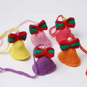 Handcrafted crochet bell pendant details, showing colorful yarn and delicate pearl bow decorations.