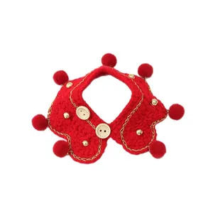 Handmade knitted red pet bib with pom poms and wooden buttons for cats and dogs.