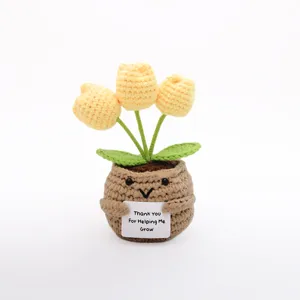 Handmade crochet yellow tulip potted plant with cute face, perfect for home decor and gifts.