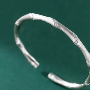Close-up detail of a sterling silver bamboo cuff bracelet with delicate sparkly stones.