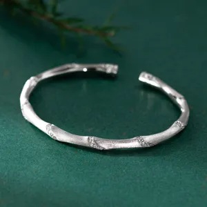 Detailed shot of S925 sterling silver brushed bamboo bangle with delicate pavé stones.