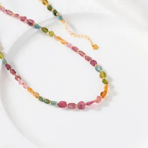 Detail shot of colorful tourmaline gemstone necklace with gold spacers and delicate chain.